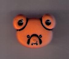Ansikte av nallebjörn orange 1,5 cm x 1,5 cm